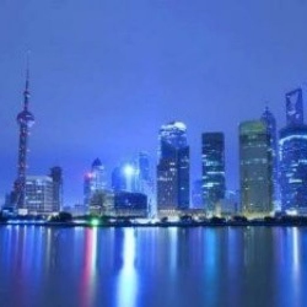 cityscape over water with moon
