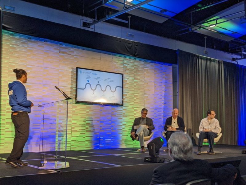 At the Quantum World Congress, Maurice Benson (left), a POLARISqb senior software engineer, presents in front of judges.